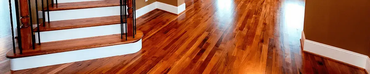 Base floor of a staircase with professionally restored wood flooring in Houston TX