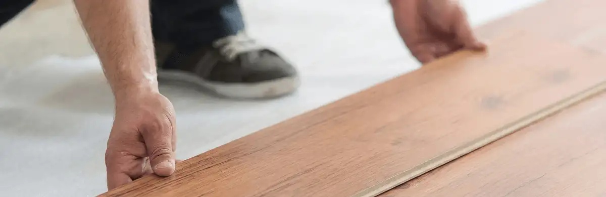 A professional installing laminate flooring in Houston, TX