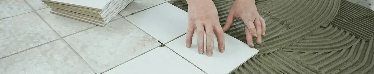 Professional installing white tile floors in Houston, TX