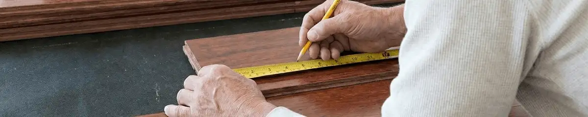A professional installing wood flooring in Houston, TX